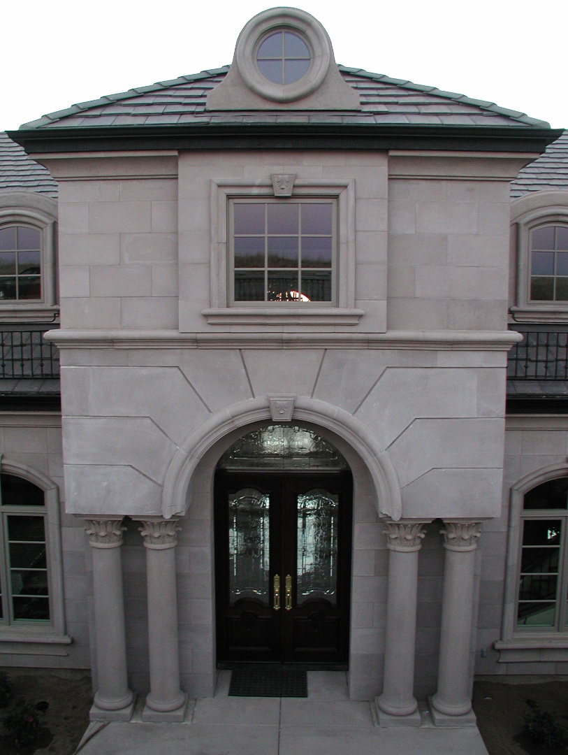 Front of a residential house fitted with cast stone columns and moulding, manufactured and installed by 