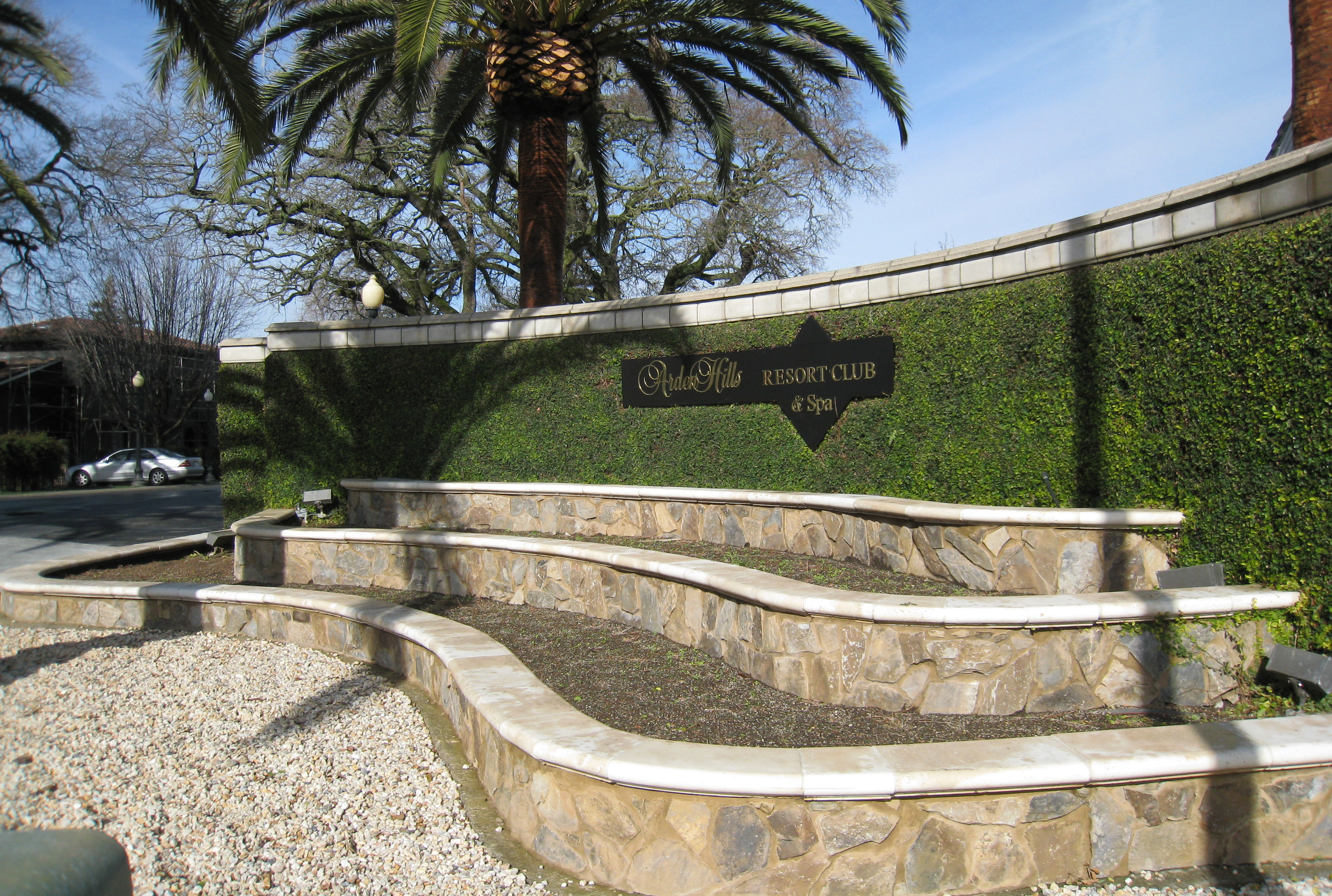 An installation of cast stone wall caps at a commercial resort entrance, manufactured and installed by 